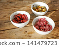 Spanish tapas with chorizo, fuet and olives in white bowls 141479723