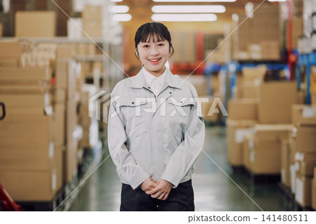 在倉庫里工作的年輕女子 在倉庫里工作的年輕女子 141480511