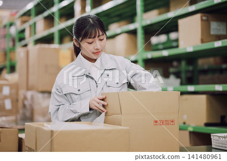 Young woman working in a warehouse Young woman working in a warehouse 141480961