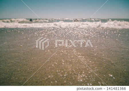 People swimming in the rough sea. View from the sandy beach People swimming in the rough sea. View from the sandy beach 141481366
