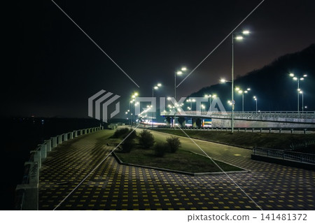Night promenade and freeway with beautiful blue lanterns. Kyiv embankment at night Night promenade and freeway with beautiful blue lanterns. Kyiv embankment at night 141481372