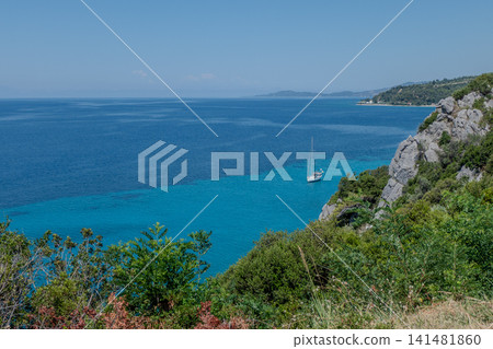 Loutra. Sailing boat in the turquoise sea of Kassandra Halkidiki Greece Loutra. Sailing boat in the turquoise sea of Kassandra Halkidiki Greece 141481860