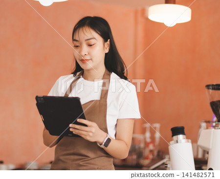 Young woman at barista school learning how to make espresso coffee. Young woman at barista school learning how to make espresso coffee. 141482571