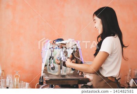 Young woman at barista school learning how to make espresso coffee. Young woman at barista school learning how to make espresso coffee. 141482581