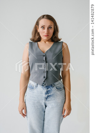 Surprised Woman Looking at Camera in Studio Surprised Woman Looking at Camera in Studio 141482879