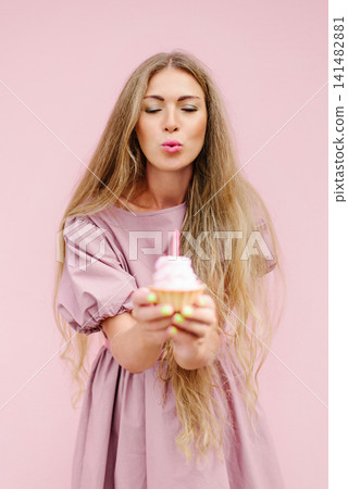 Beautiful Woman Blowing Candle On Cupcake Beautiful Woman Blowing Candle On Cupcake 141482881