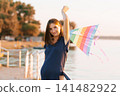 Pregnant Woman With Colorful Kite At Sunset 141482922