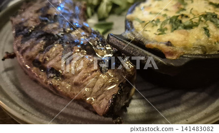 Grilled steak and baked potato on a plate Grilled steak and baked potato on a plate 141483082