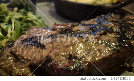 Grilled steak with greens on a plate Grilled steak with greens on a plate 141483093