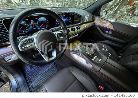 Luxury car interior with digital dashboard and wood trim 141483160