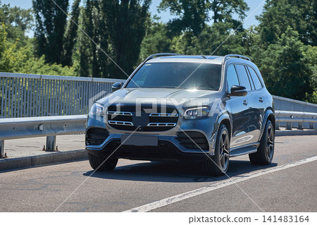 Luxury SUV driving on a sunny highway Luxury SUV driving on a sunny highway 141483164