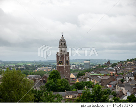 Historic church tower above a small town skyline Historic church tower above a small town skyline 141483170