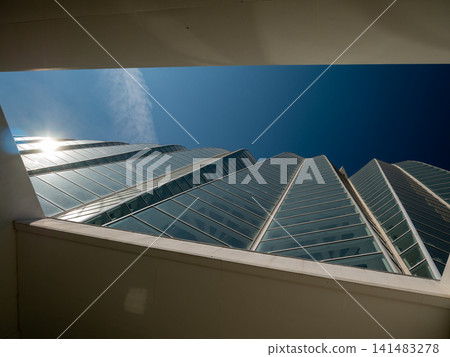 Modern glass office building with dramatic sky Modern glass office building with dramatic sky 141483278