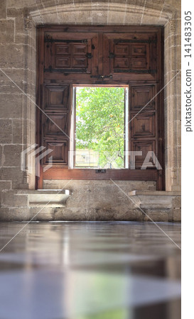Ancient stone doorway with open wooden window frame Ancient stone doorway with open wooden window frame 141483305