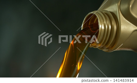 Pouring Fresh New Motor Oil into Car's Engine 141483914