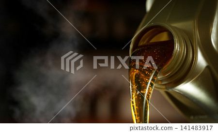 Pouring Fresh New Motor Oil into Car's Engine 141483917