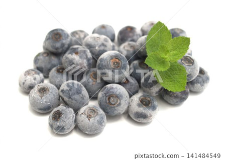 Harvested frozen blueberries and peppermint leaves Harvested frozen blueberries and peppermint leaves 141484549