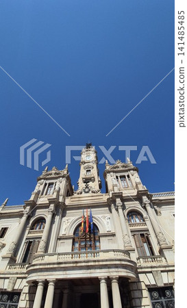 Historic clock tower on ornate civic building against blue sky Historic clock tower on ornate civic building against blue sky 141485485