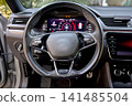 Modern car interior with digital dashboard and steering wheel 141485504