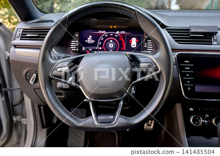 Modern car interior with digital dashboard and steering wheel 141485504