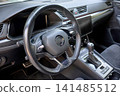 Modern car interior with steering wheel and dashboard 141485512
