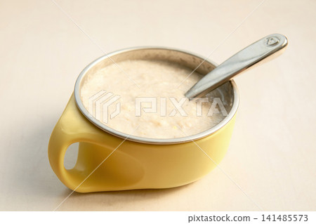 Baby Food Porridge in Yellow Bowl with Spoon	 141485573