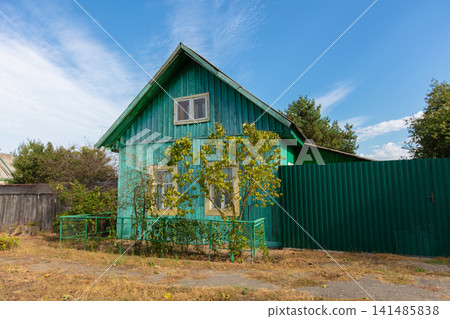 Green wooden one-story village house. Green wooden one-story village house. 141485838