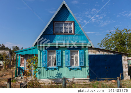 A small wooden country house on a summer street. A small wooden country house on a summer street. 141485876