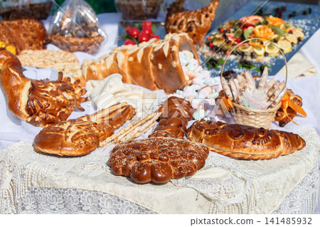 Artisan baked goods displayed at a festive outdoor market showcasing traditional breads and pastries Artisan baked goods displayed at a festive outdoor market showcasing traditional breads and pastries 141485932