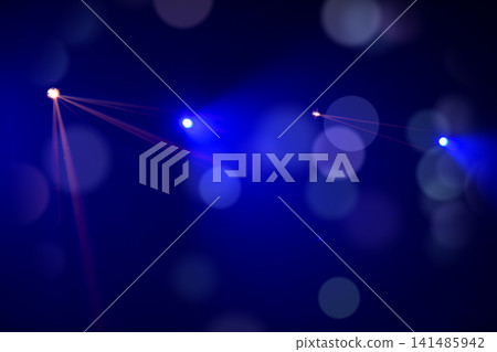 Colorful laser lights create a vibrant atmosphere during an evening event at a concert hall in the city 141485942
