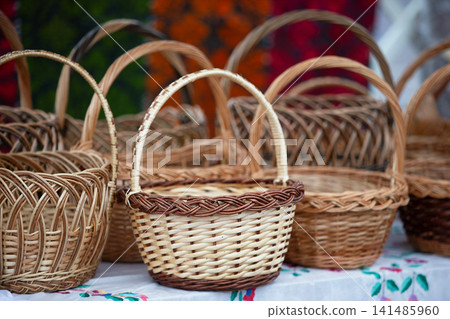 Handcrafted woven baskets displayed at a local market showcasing traditional craftsmanship and unique designs Handcrafted woven baskets displayed at a local market showcasing traditional craftsmanship and unique designs 141485960