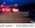 Night Traffic Congestion on Highway With Cars and Tail Lights During Rush Hour Commute 141486189