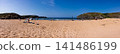 Sunny Panoramic Sandy Beach With Cliffs, Sea and People Enjoying Summer Holiday 141486199