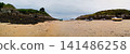 Beached Fishing Boats On Sandy Cove At Low Tide Between Rocky Cliffs Under Overcast Sky 141486258