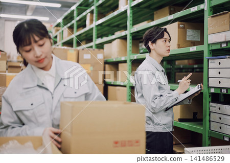 Young men and women working in a warehouse Young men and women working in a warehouse 141486529