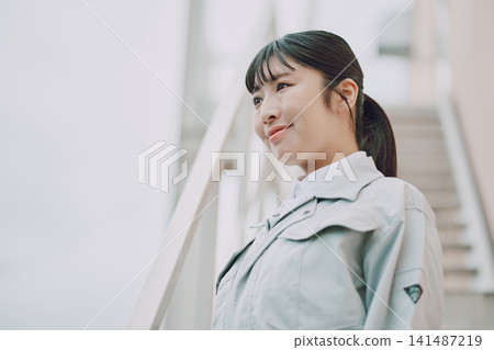 Young woman in work clothes Young woman in work clothes 141487219