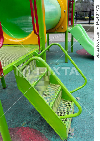 Short metal staircase to access the playground equipment with climbers and slides. Short metal staircase to access the playground equipment with climbers and slides. 141487779