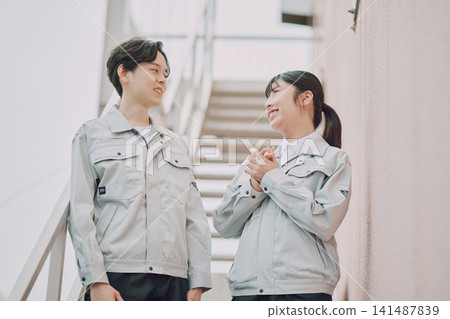 Portrait of a young man and woman in work clothes Portrait of a young man and woman in work clothes 141487839