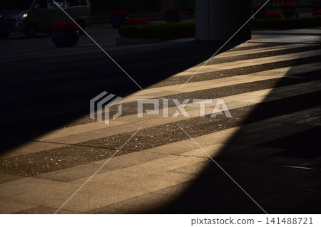 Close-up of the ground with sunlight. Sunlight of pedestrian walkway of the city. Street pattern. For background use. Close-up of the ground with sunlight. Sunlight of pedestrian walkway of the city. Street pattern. For background use. 141488721