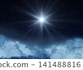 Glowing Star or Christmas Star over the Clouds Shines Brightly in the Starry Night Sky. 141488816