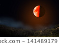 Eclipse - Blood moon with orange surface over forest at night. Half of the moon is illuminated. 141489179