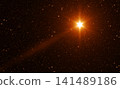 Bright Golden Christmas Star with Rays in the Starry Sky 141489186
