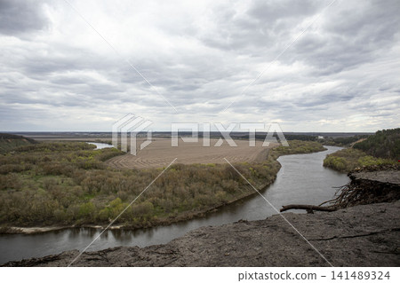 High angle view of the Don River bend from a sandy cliff under a cloudy sky in spring High angle view of the Don River bend from a sandy cliff under a cloudy sky in spring 141489324
