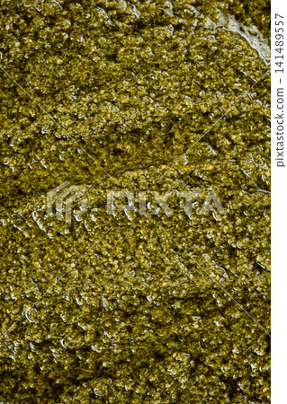 Close-up texture of fresh green pesto sauce with olive oil 141489557