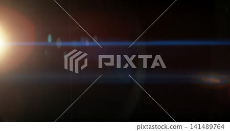 Blue anamorphic lens flare overlay featuring cinematic horizontal light streaks, soft optical reflections and subtle glow on a black background. Premium VFX element for compositing and film editing. 141489764