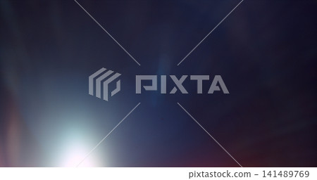 Abstract cinematic lens flare overlay texture featuring soft optical reflections, blue light artifacts and subtle glow on a black background. Premium VFX asset for compositing and film editing. Abstract cinematic lens flare overlay texture featuring soft optical reflections, blue light artifacts and subtle glow on a black background. Premium VFX asset for compositing and film editing. 141489769