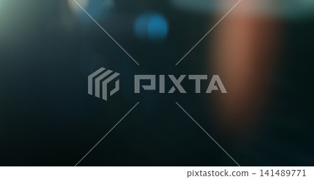 Cinematic lens flare overlay featuring soft optical reflections, subtle blue and warm orange light artifacts and realistic glow on a black background. Premium VFX asset for film compositing. 141489771