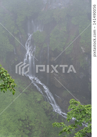 Kegon Falls shrouded in the thick mist of the rainy season, with its delicate water flowing down the rocky cliffs. Kegon Falls shrouded in the thick mist of the rainy season, with its delicate water flowing down the rocky cliffs. 141490056
