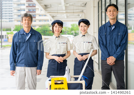 Four men and women who are staff members for building cleaning and facility maintenance. 141490261