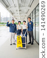 Four men and women who are staff members for building cleaning and facility maintenance. 141490269